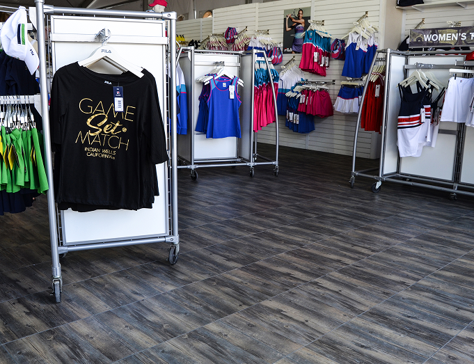 Retail display booth with FILA tennis branding and merchandise.