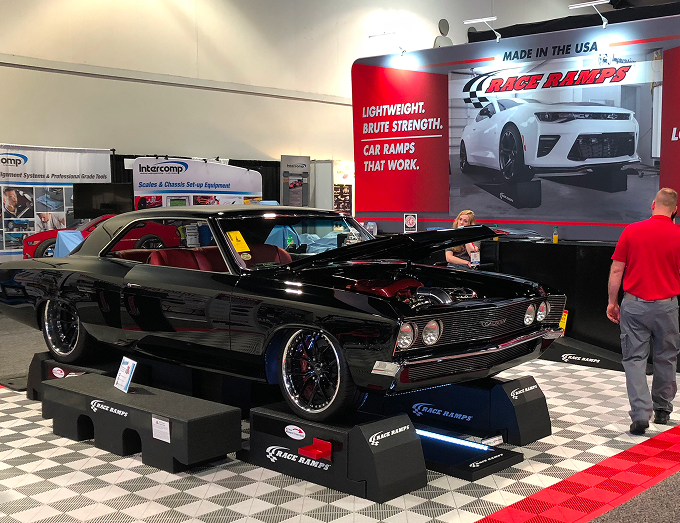 Black classic car on display at a car show with 'Race Ramps' branding.