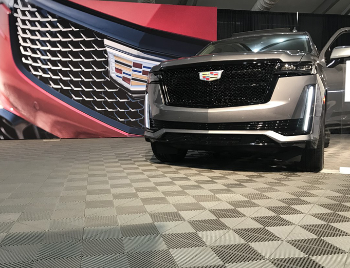 Cadillac SUV in a showroom with a checkered floor